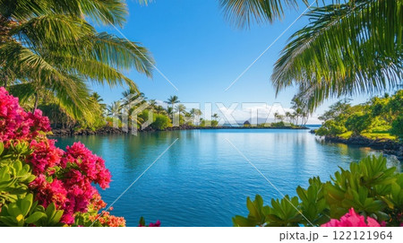 Serene tropical lagoon scene with vibrant flowers, palm trees, and clear blue water under a sunny sky. 122121964