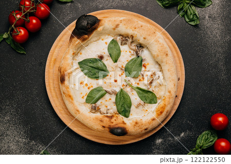 Gourmet white pizza with creamy mozzarella, mushrooms, and fresh spinach on a rustic wooden plate Gourmet white pizza with creamy mozzarella, mushrooms, and fresh spinach on a rustic wooden plate 122122550