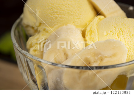 creamy ice cream with yellow banana slices in a glass cup creamy ice cream with yellow banana slices in a glass cup 122123985