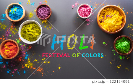 Happy Holi decoration, the indian festival.Top view of colorful holi powder and the text on dark background. Happy Holi decoration, the indian festival.Top view of colorful holi powder and the text on dark background. 122124091