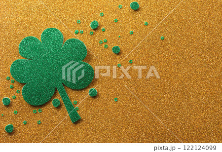 Happy St Patrick's Day decoration concept made from shamrocks ( clover leaf) on golden background. Happy St Patrick's Day decoration concept made from shamrocks ( clover leaf) on golden background. 122124099