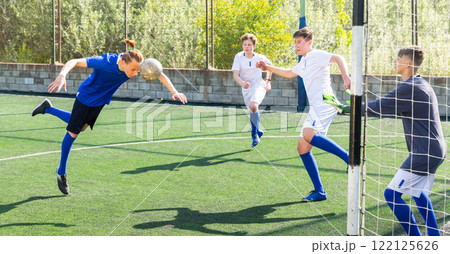 Young football player doing header 122125626