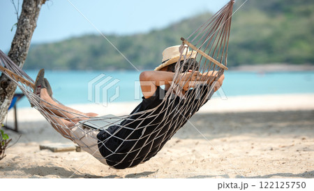 Lifestyle freelance man relax and sleeping on the hammock after using laptop working and relax on the beach Lifestyle freelance man relax and sleeping on the hammock after using laptop working and relax on the beach 122125750