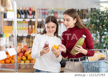 Mom and daughter choose smoothies Mom and daughter choose smoothies 122125765