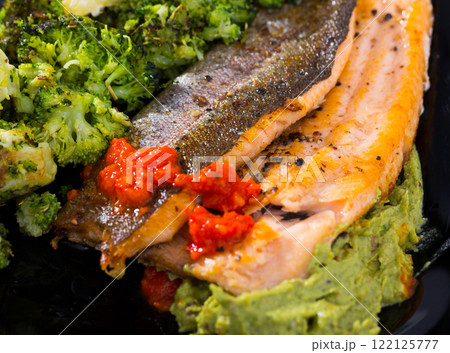 Grilled trout with broccoli, guacamole and tomato sauce Grilled trout with broccoli, guacamole and tomato sauce 122125777