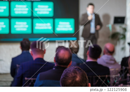 Audience attentively listening to speaker during professional presentation event 122125908