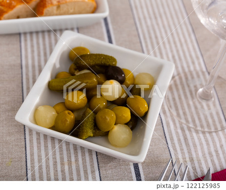 Plate with pickled olives, gherkins and baby onions 122125985
