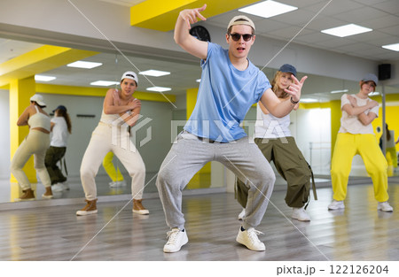 Teenage boy training breakdance Toprock moves in dance hall Teenage boy training breakdance Toprock moves in dance hall 122126204