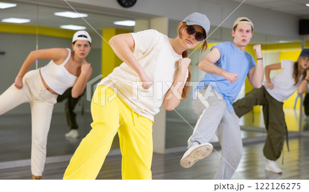 Young girl training breakdance Footwork moves in dance hall Young girl training breakdance Footwork moves in dance hall 122126275