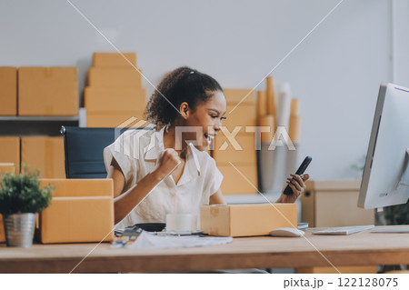 Portrait of Starting small businesses SME owners female entrepreneurs working on receipt box and check online orders to prepare to pack the boxes, sell to customers, SME business ideas online. 122128075