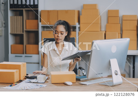 Portrait of Starting small businesses SME owners female entrepreneurs working on receipt box and check online orders to prepare to pack the boxes, sell to customers, SME business ideas online. 122128076