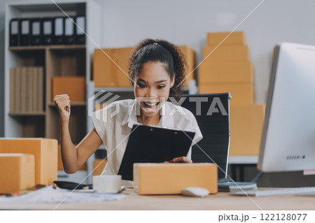 Portrait of Starting small businesses SME owners female entrepreneurs working on receipt box and check online orders to prepare to pack the boxes, sell to customers, SME business ideas online. 122128077
