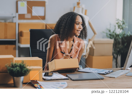 Portrait of Starting small businesses SME owners female entrepreneurs working on receipt box and check online orders to prepare to pack the boxes, sell to customers, SME business ideas online. 122128104