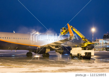 Ground deicing of a passenger aircraft on the night airport apron Ground deicing of a passenger aircraft on the night airport apron 122128955