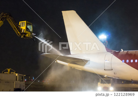 Ground deicing of the tail section of a passenger aircraft at night Ground deicing of the tail section of a passenger aircraft at night 122128969