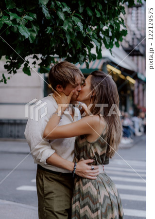 A Romantic Couple Embracing Each Other in a Beautiful Urban Green Setting Surrounded by Nature 122129575
