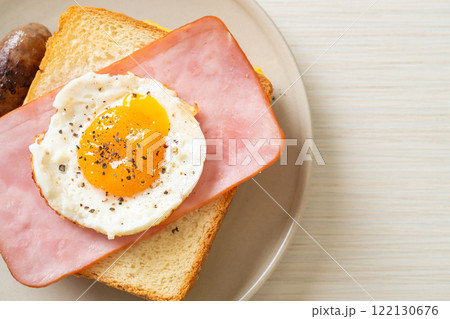 bread toasted cheese topped ham and fried egg with pork sausage bread toasted cheese topped ham and fried egg with pork sausage 122130676