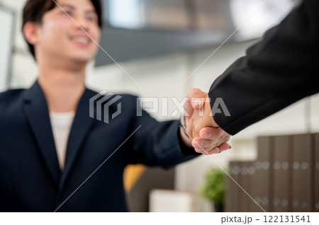 A close-up of a businessman shaking hands with his colleague or business partner. A close-up of a businessman shaking hands with his colleague or business partner. 122131541