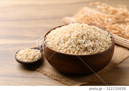 Organic Jasmine brown rice seed in wooden bowl with spoon, Thai Rice Organic Jasmine brown rice seed in wooden bowl with spoon, Thai Rice 122132638