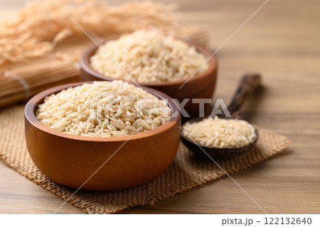 Organic Jasmine brown rice seed in wooden bowl with spoon, Thai Rice Organic Jasmine brown rice seed in wooden bowl with spoon, Thai Rice 122132640