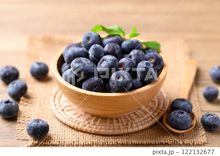 Blueberries in wooden bowl on wooden table, Healthy fruit, Food ingredient Blueberries in wooden bowl on wooden table, Healthy fruit, Food ingredient 122132677