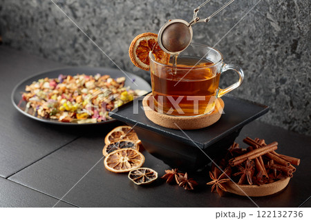 Cup of herbal tea with ingredients and slices of dried orange slices. Cup of herbal tea with ingredients and slices of dried orange slices. 122132736