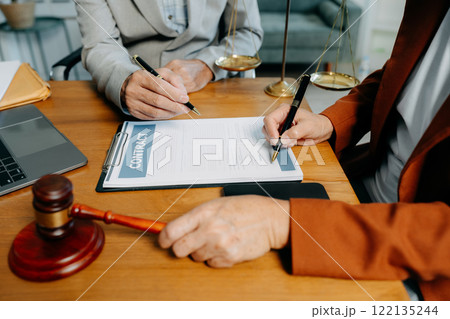 Businessman and Male lawyer or judge consult having team meeting with client, Law and Legal services concept in office. Businessman and Male lawyer or judge consult having team meeting with client, Law and Legal services concept in office. 122135244