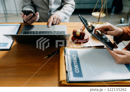 Justice and law concept. judge in a courtroom the gavel, working with digital tablet computer on wood table. 122135262