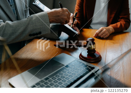 Legal counsel presents to the client a signed contract with legal law. justice and lawyer concept in office. 122135270
