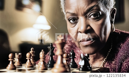 Senior woman playing chess at home 122135834