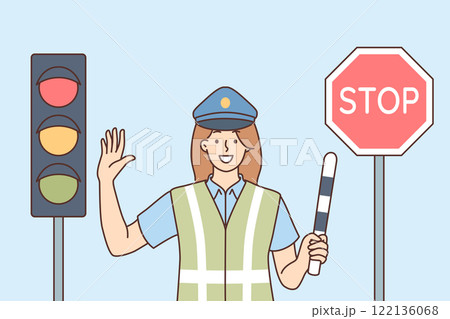 Woman traffic inspector regulates movement of cars, standing near traffic light and stop sign 122136068