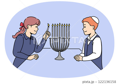 Jewish children stand near minora with burning candles, preparing for traditional holiday hanukkah 122136158