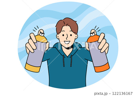 Man street artist draws graffiti holding two cans of paint in hands and with smile looks at screen Man street artist draws graffiti holding two cans of paint in hands and with smile looks at screen 122136167