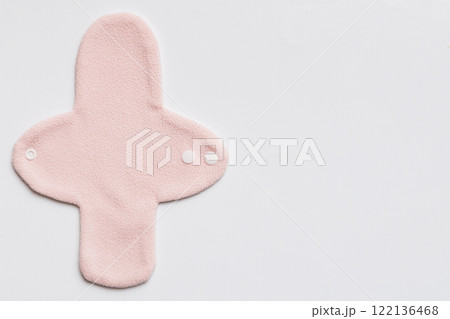 Eco-friendly reusable fabric women's pads. set of colorful bright reusable menstrual pads. zero waste woman periods concept top view with copy space Eco-friendly reusable fabric women's pads. set of colorful bright reusable menstrual pads. zero waste woman periods concept top view with copy space 122136468