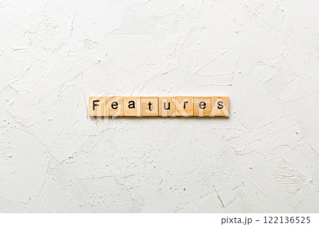 features word written on wood block. features text on table, concept features word written on wood block. features text on table, concept 122136525