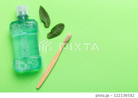 Mouthwash and fresh mint on colored background, top view with copy space for text Mouthwash and fresh mint on colored background, top view with copy space for text 122136582