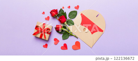 Valentine day composition with envelope, rose flower and red heart on table. Top view, flat lay, copy space Holiday concept 122136672