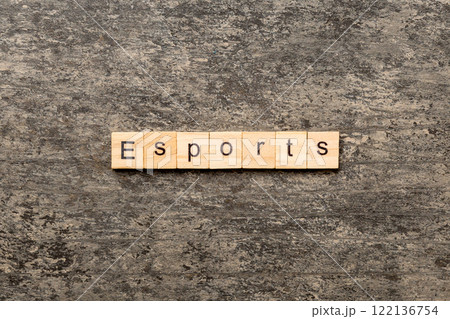 Esports word written on wood block. Esports text on cement table for your desing, Top view concept Esports word written on wood block. Esports text on cement table for your desing, Top view concept 122136754