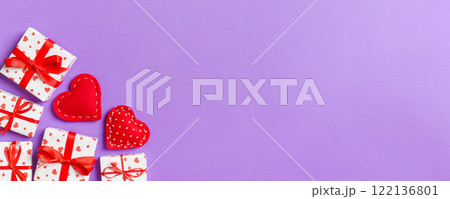 Top view colorful valentine background made of gift boxes and red textile hearts. Valentine's Day concept with copy space Top view colorful valentine background made of gift boxes and red textile hearts. Valentine's Day concept with copy space 122136801