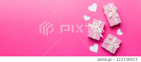 Valentine day composition: red gift box with bow and heart. Christmas present. View from above. Space for text. Holday greeting card 122136823