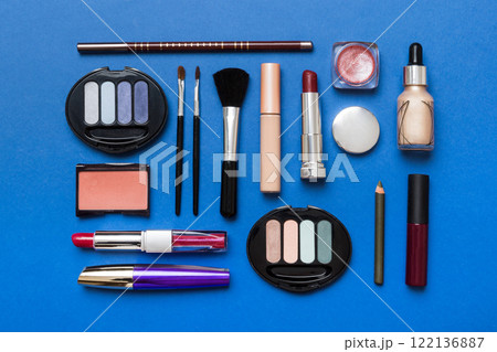 Professional makeup tools. Top view. Flat lay. Beauty, decorative cosmetics. Makeup brushes set and color eyeshadow palette on table background. Minimalistic style 122136887