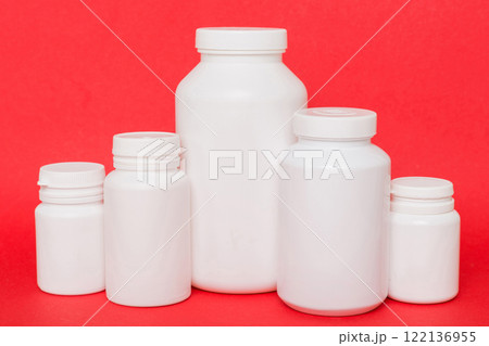 supplement pills with medicine bottle health care and medical top view. Vitamin tablets. Top view mockup bottle for pills and vitamins with green leaves, natural organic bio supplement, copy space 122136955
