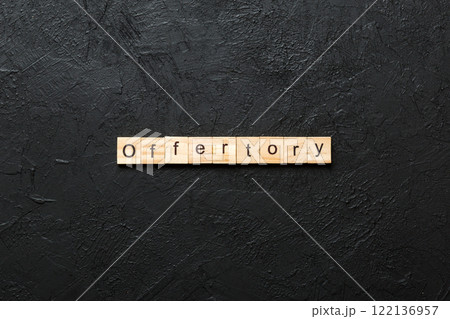 offertory word written on wood block. offertory text on table, concept 122136957