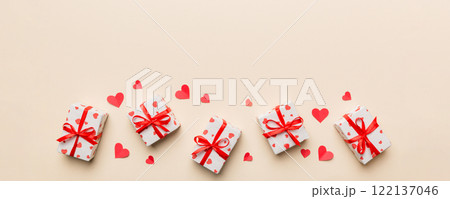 Valentine day composition: red gift box with bow and heart. Christmas present. View from above. Space for text. Holday greeting card 122137046