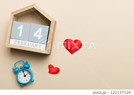 Valentine Day theme with wooden block calendar. Greeting card template for Valentines Day. Top view, copy space for text Valentine Day theme with wooden block calendar. Greeting card template for Valentines Day. Top view, copy space for text 122137120