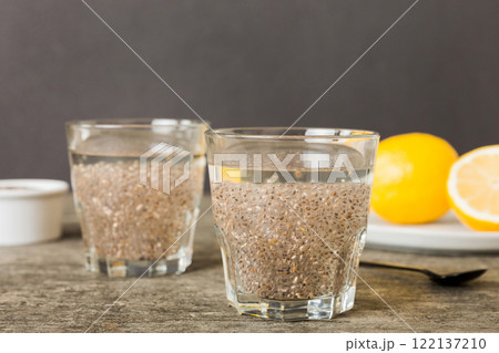 Healthy breakfast or morning with chia seeds and lemon on table background, vegetarian food, diet and health concept. Chia pudding with lemon Healthy breakfast or morning with chia seeds and lemon on table background, vegetarian food, diet and health concept. Chia pudding with lemon 122137210