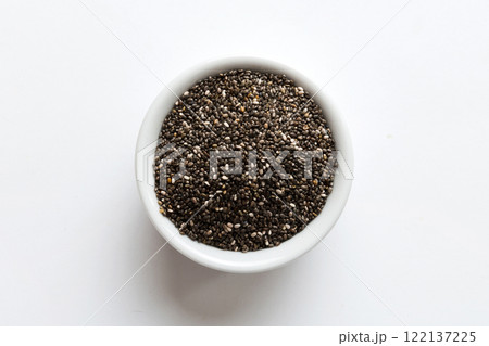 Chia seeds in bowl on colored background. Healthy Salvia hispanica in small bowl. Healthy superfood Chia seeds in bowl on colored background. Healthy Salvia hispanica in small bowl. Healthy superfood 122137225