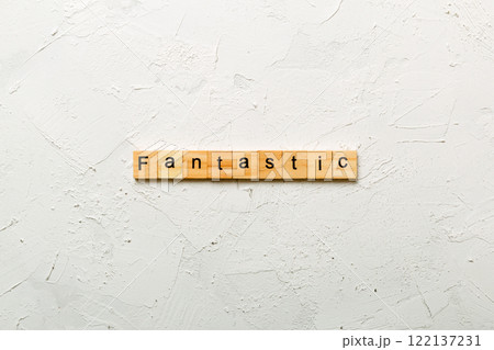 fantastic word written on wood block. fantastic text on cement table for your desing, concept 122137231