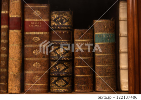 Row of vintage bibles with decorative leather bindings 122137486