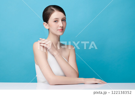 Beautiful young woman with clean fresh skin on blue background, Face care, Facial treatment, Cosmetology, beauty and spa, women portrait. Beautiful young woman with clean fresh skin on blue background, Face care, Facial treatment, Cosmetology, beauty and spa, women portrait. 122138352